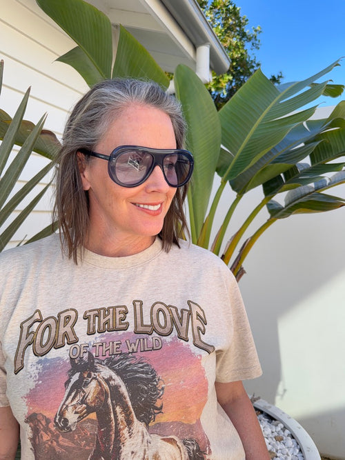 Model wearing Midnight Monarchy navy blue acetate sunglasses with light blue UV400 lenses