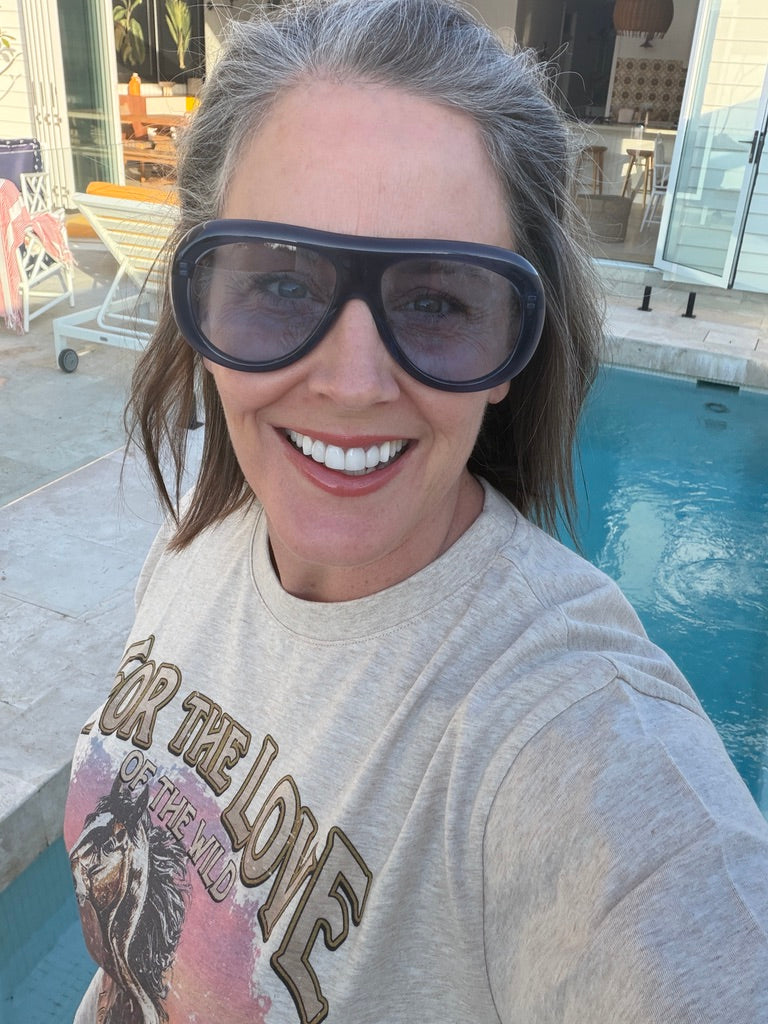 Woman wearing Mignight Monarchy Navy blue acetate sunglasses with light blue UV400 lenses