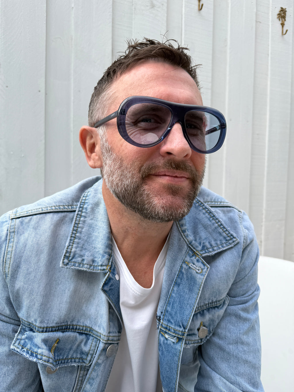 Man wearing Midnight Monarchy navy blue acetate sunglasses with light blue UV400 lenses